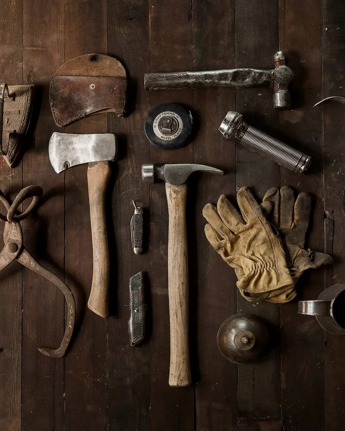 Hand tools laid out on a wooden workbench